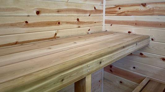 the inside of a pine wood sauna with cedar wood benches