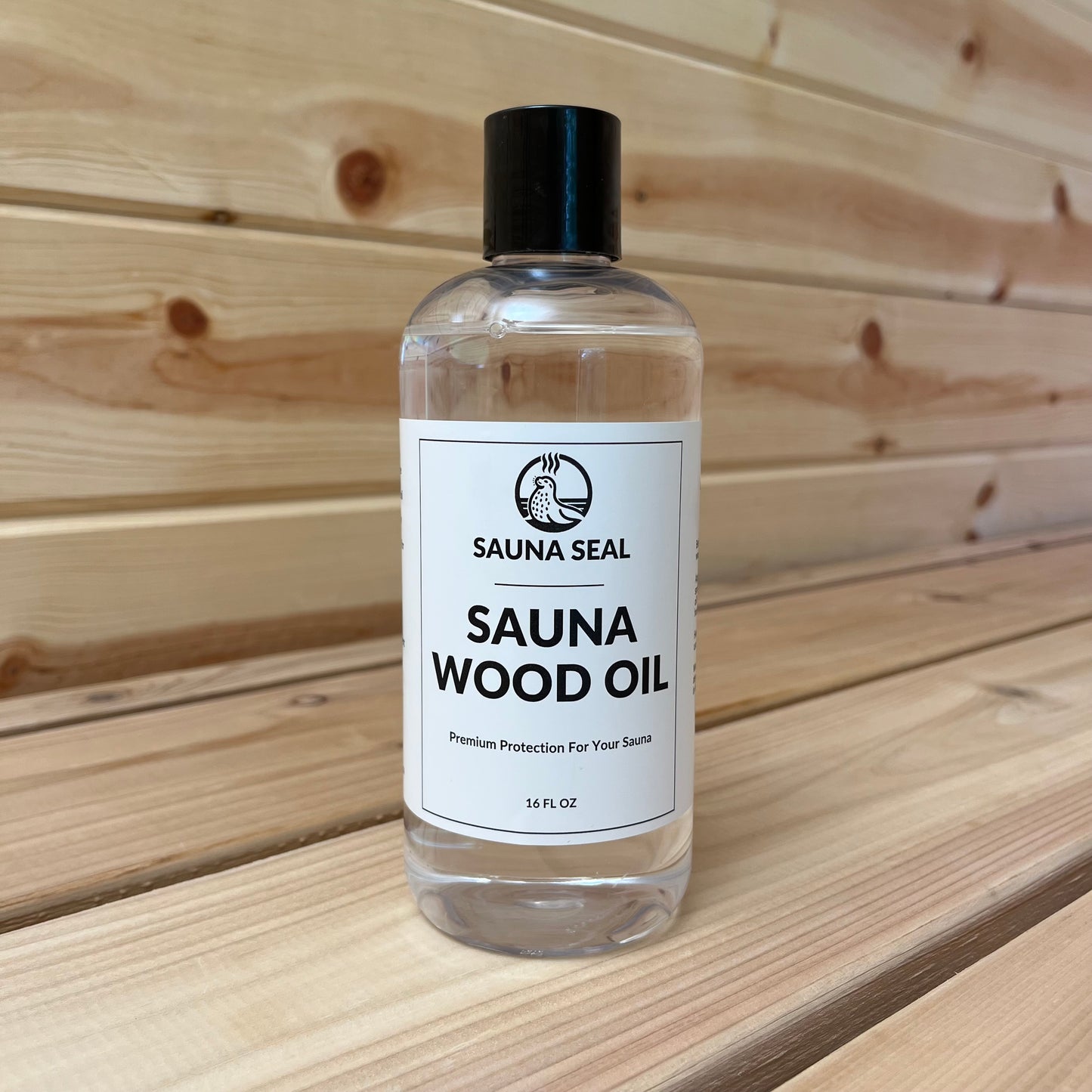 Sauna Seal Wood Oil 16oz bottle with white label, back cap a sauna wood background.