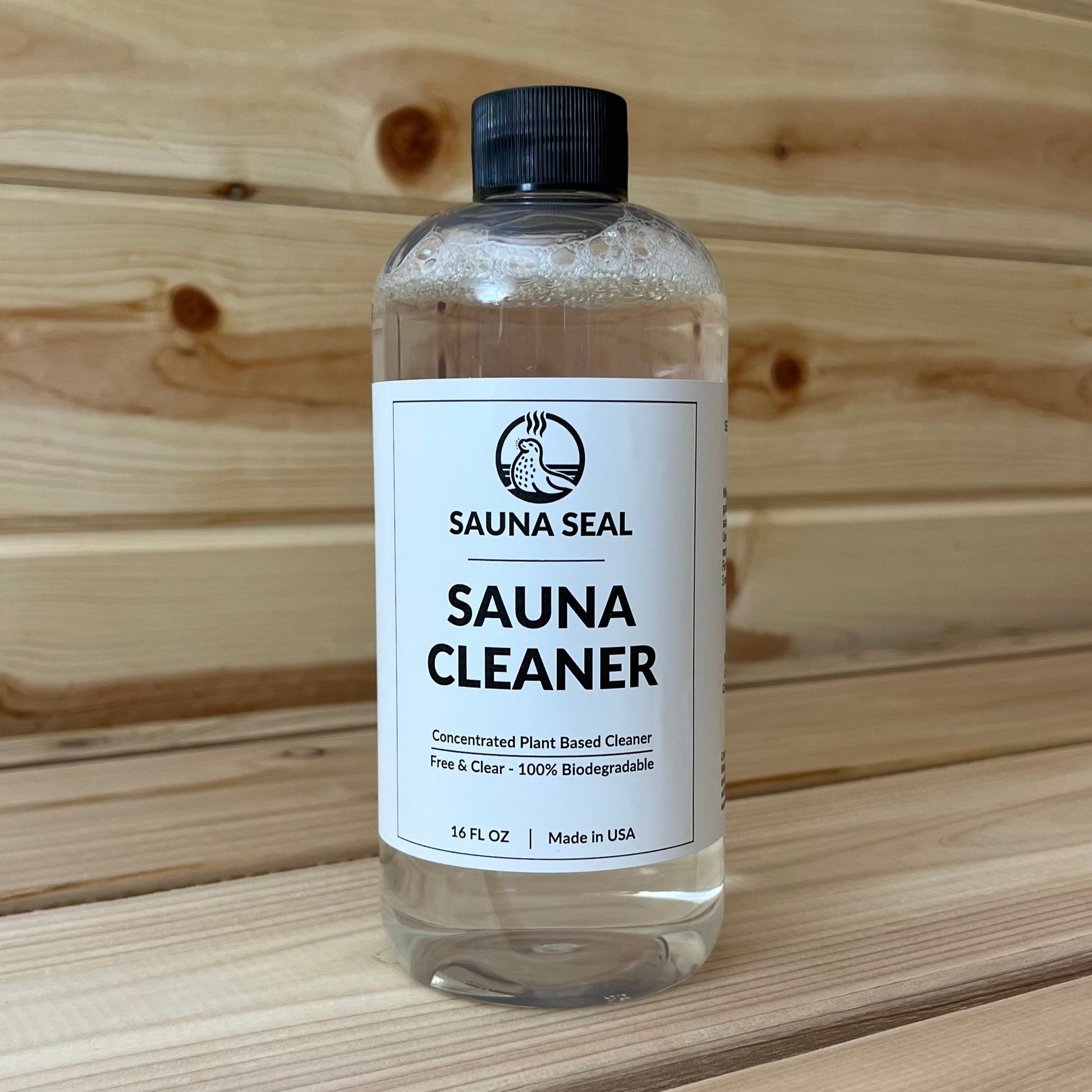 Sauna Seal Sauna Cleaner 16 oz bottle with white label and wood in the background