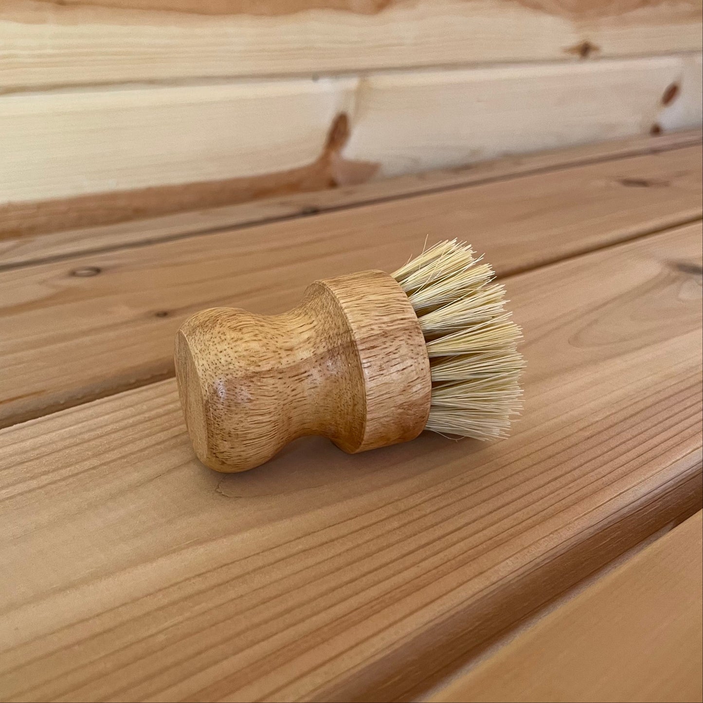 Wooden brush with bristles on a wooden surface