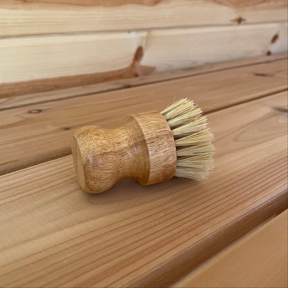 Wooden brush with bristles on a wooden surface