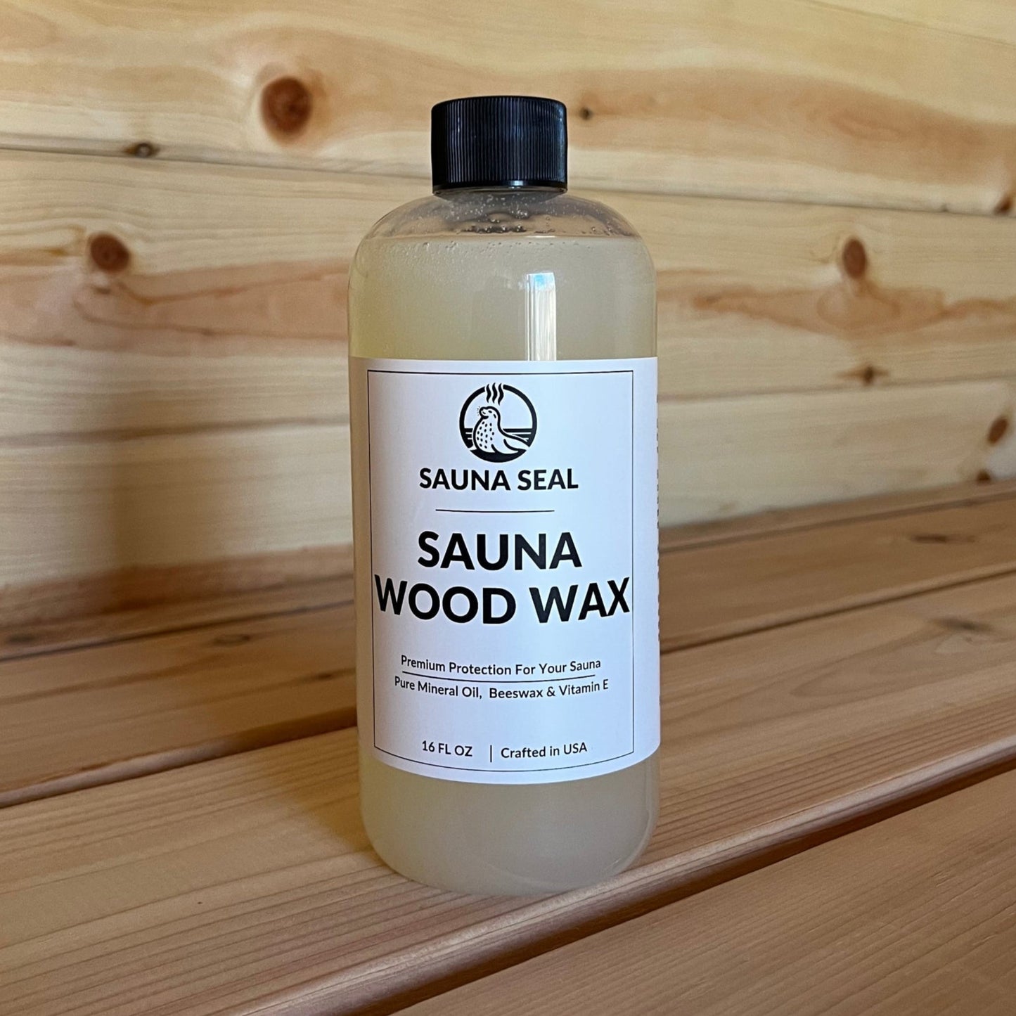 Sauna Seal Wood Wax bottle with white label on wood sauna bench