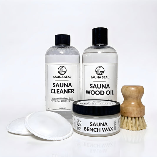 Sauna Seal Complete Sauna Care Kit: Sauna Cleaner 16oz, Sauna Wood Oil 16oz, Sauna Bench Wax 7oz, two applicator pads and bench scrub brush on a white background